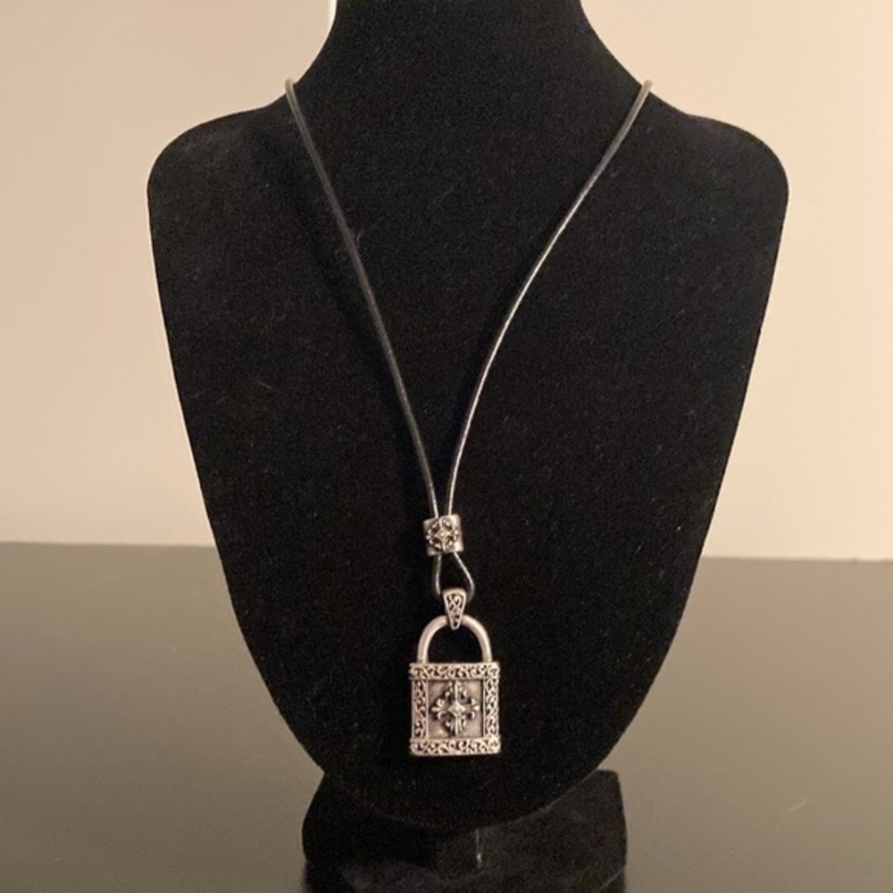 Stigma necklace with black cord and silver tone cross pendant